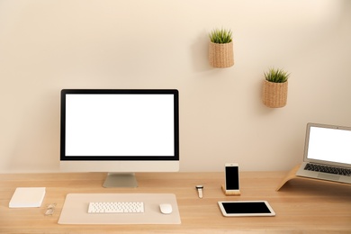 Stylish workplace interior with modern computer on table. Mockup for design