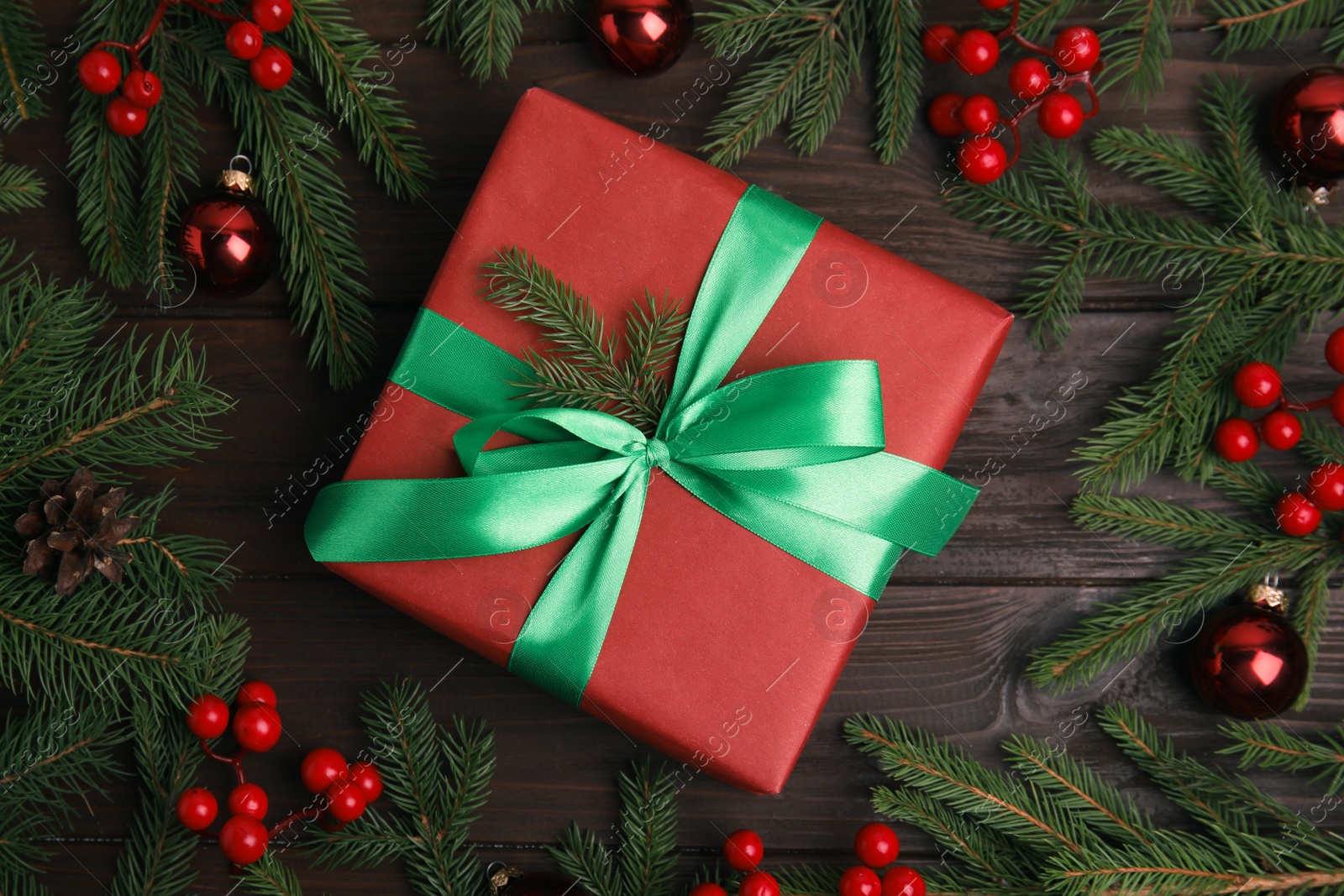 Photo of Flat lay composition with red Christmas gift box on wooden table