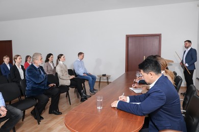 Business conference. People in meeting room listening to speaker report