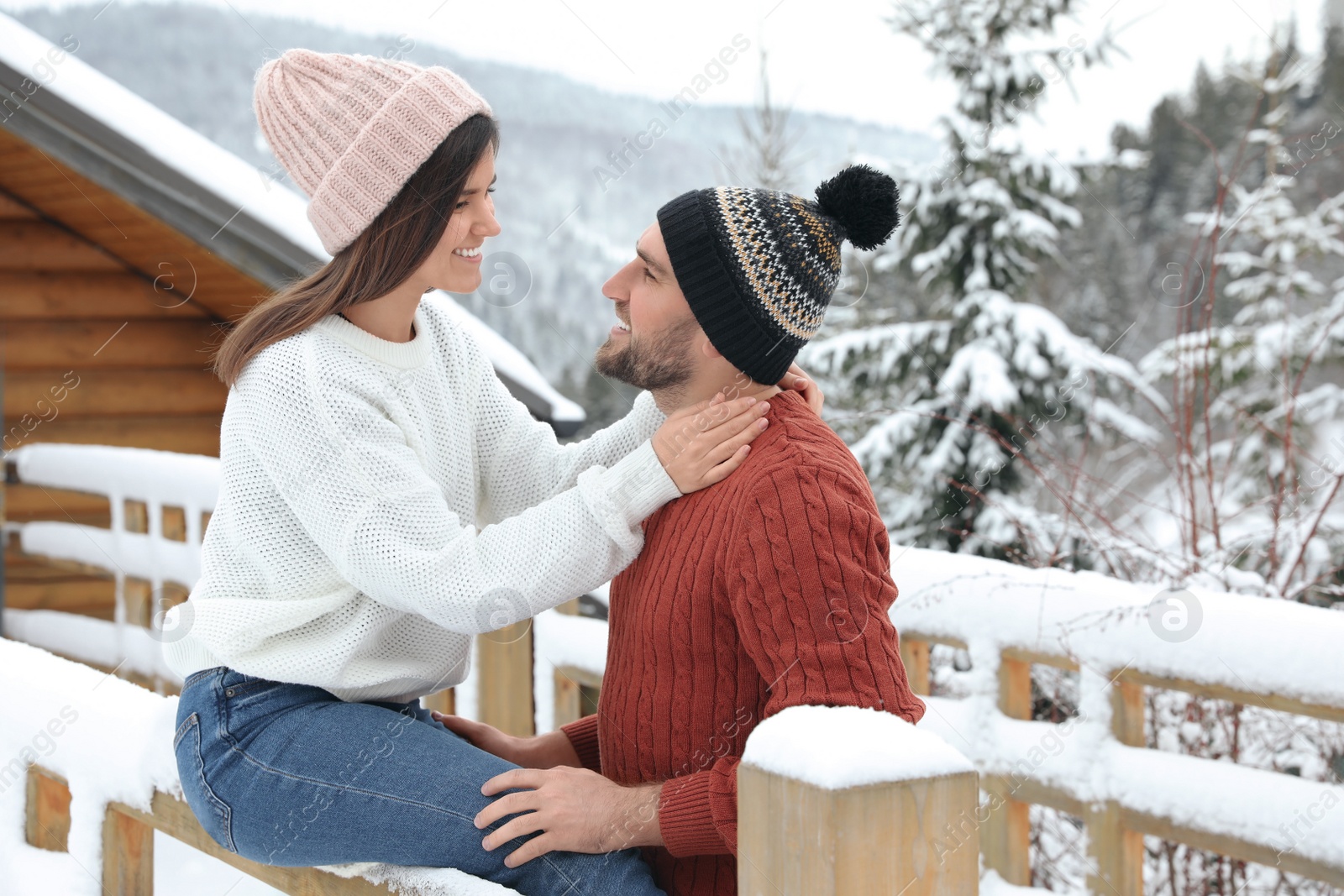 Photo of Happy couple in warm sweaters outdoors on winter day