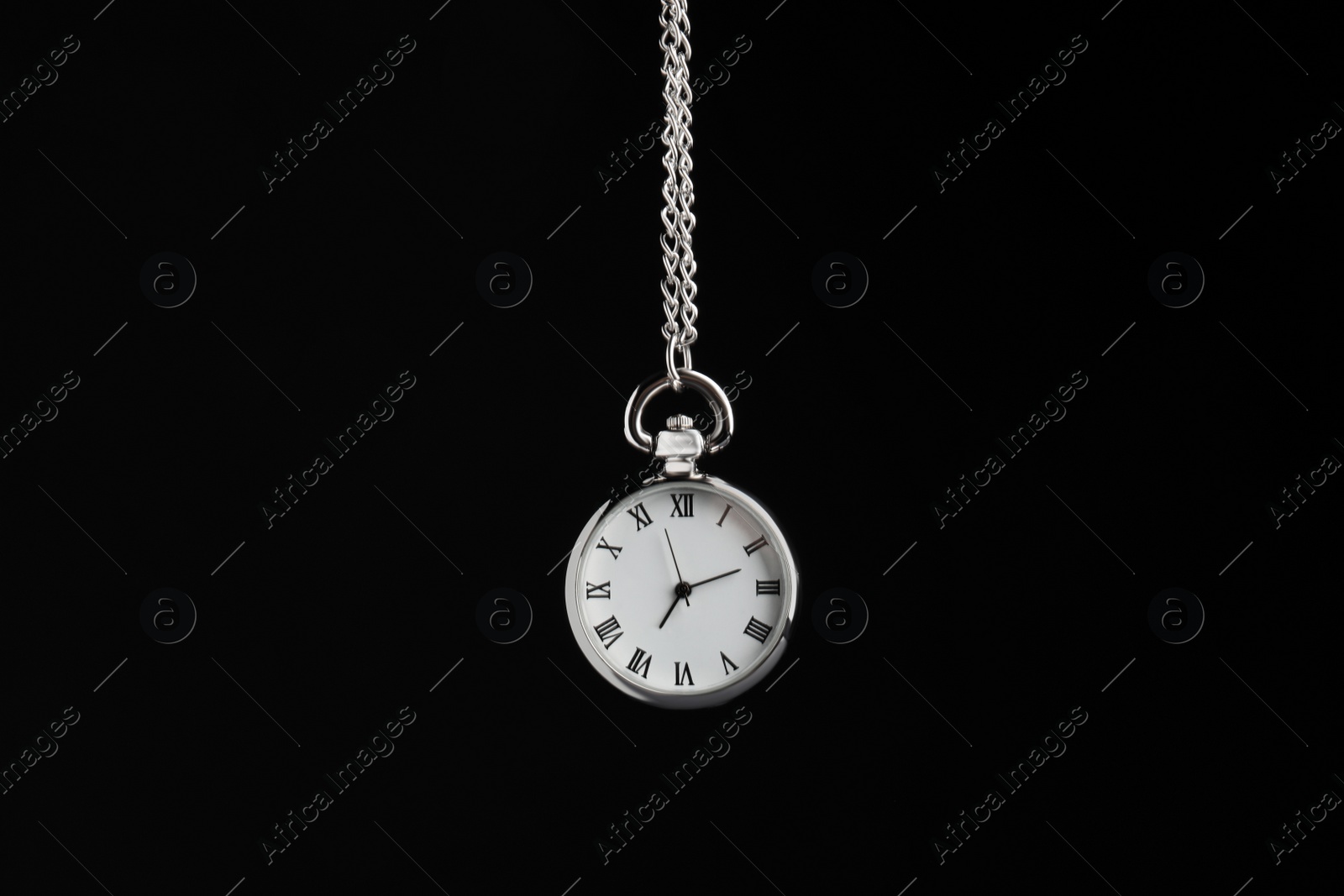 Photo of Beautiful vintage pocket watch with silver chain on black background. Hypnosis session