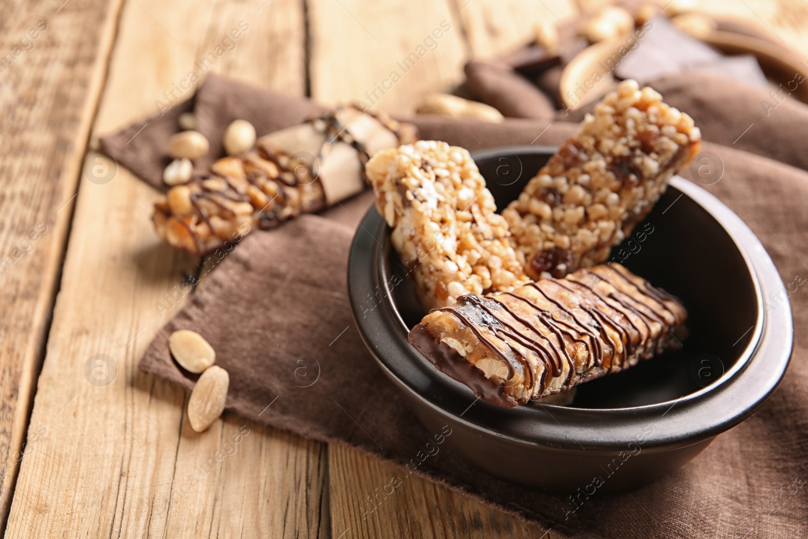 Photo of Plate with different homemade grain cereal bars on wooden table