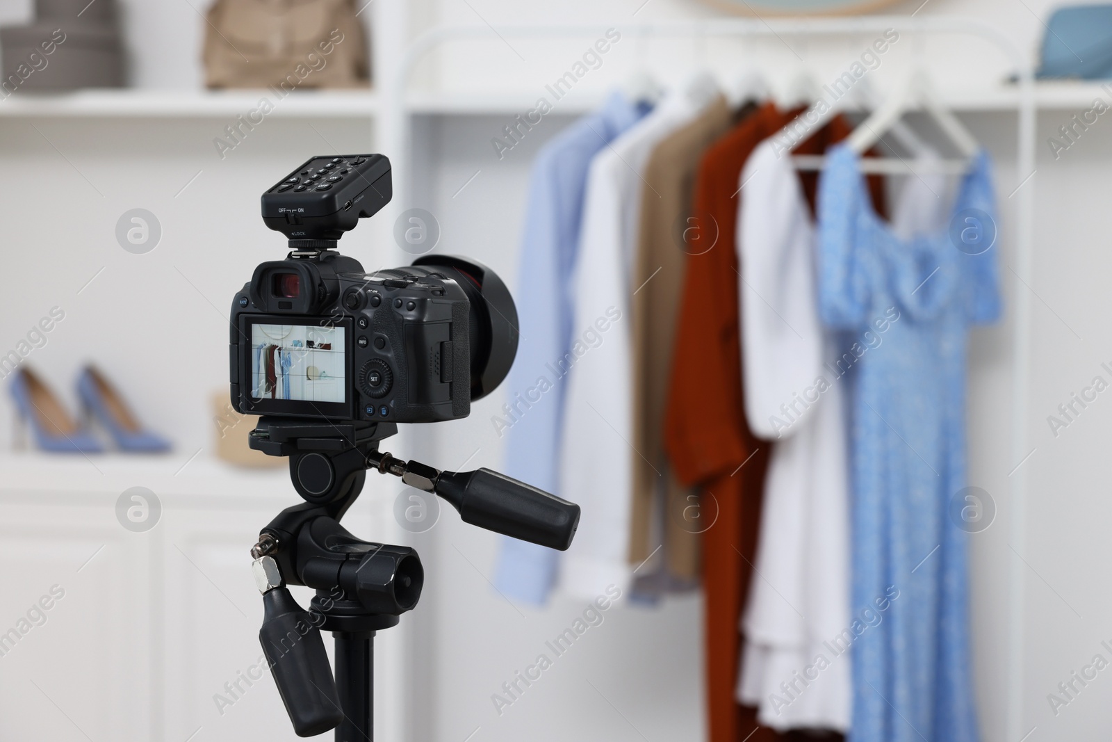 Photo of Fashion blogger's workplace. Stylish clothes and accessories indoors, focus on camera
