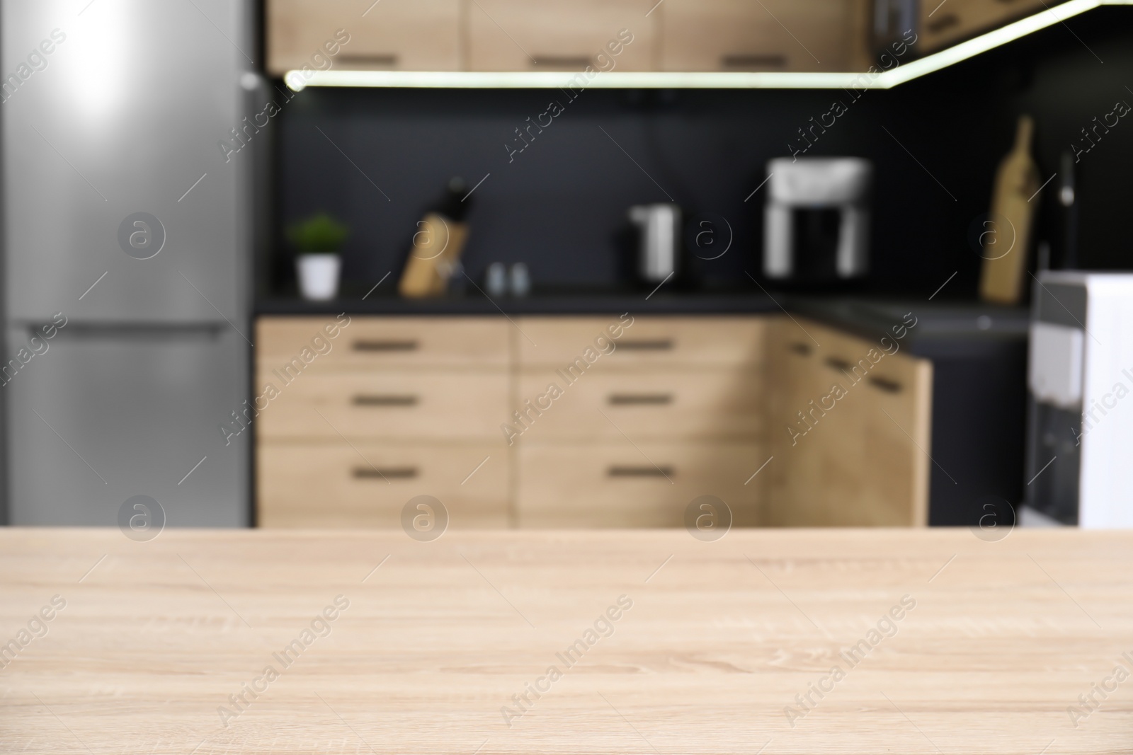 Photo of Countertop and blurred view of cozy modern kitchen interior on background