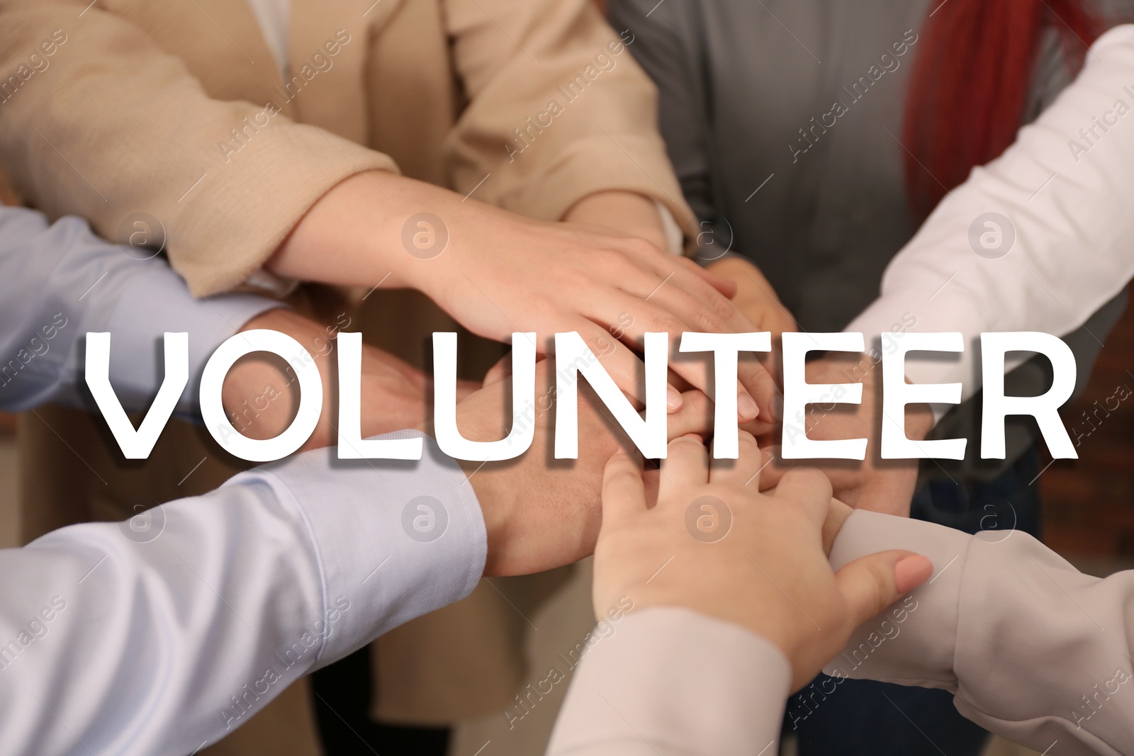 Image of Group of volunteers putting hands together, closeup