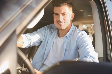 Photo of Handsome man in car on road trip