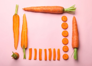 Flat lay composition with fresh carrots on color background. Space for text