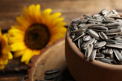 Raw sunflower seeds in bowl on table, closeup