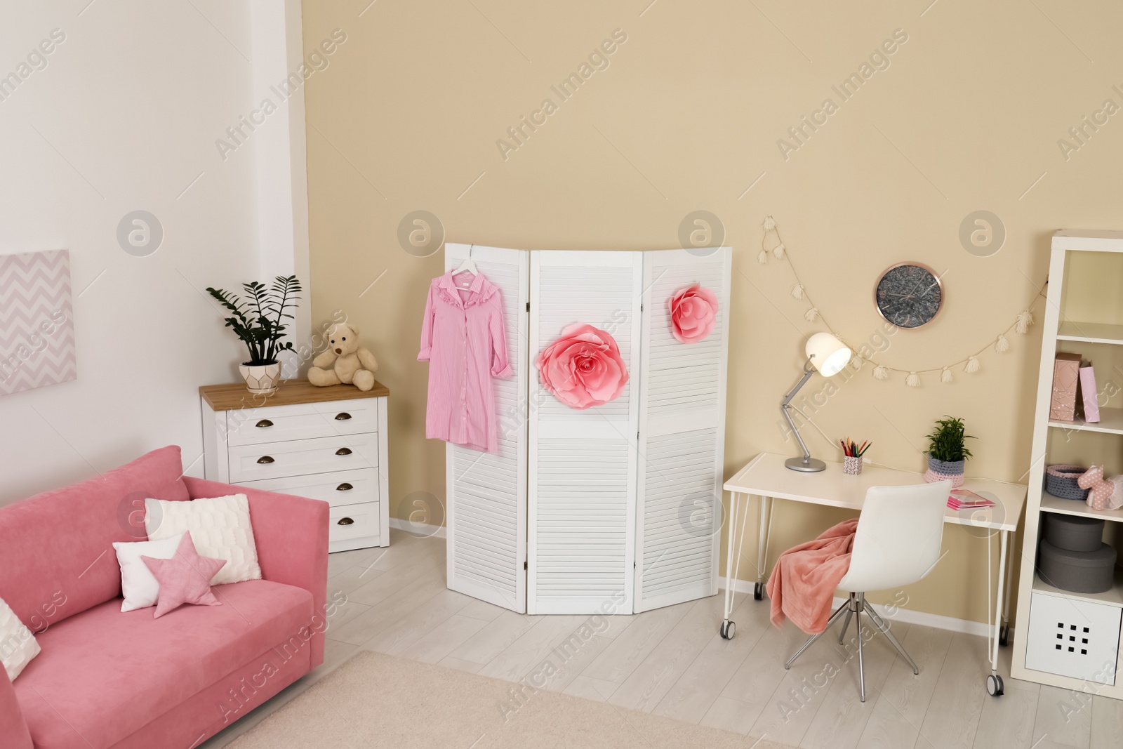 Photo of Cozy child room interior with sofa, study station and modern decor elements