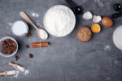 Photo of Flat lay composition with flour, eggs and jug of milk on grey background