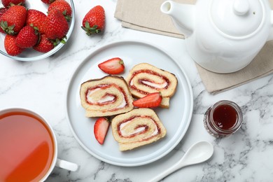 Photo of Tasty cake roll with strawberry jam and cream on white marble table, flat lay