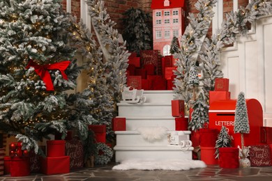 Christmas tree, gift boxes and festive decor indoors. Interior design