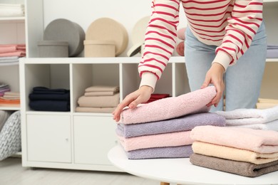Photo of Woman choosing towels in home textiles store, closeup. Space for text