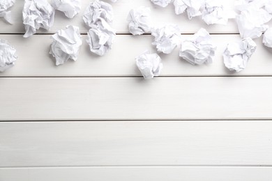 Crumpled sheets of paper on white wooden background, flat lay. Space for text