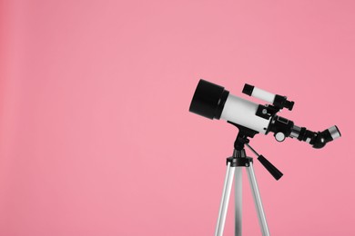 Photo of Tripod with modern telescope on pale pink background, space for text