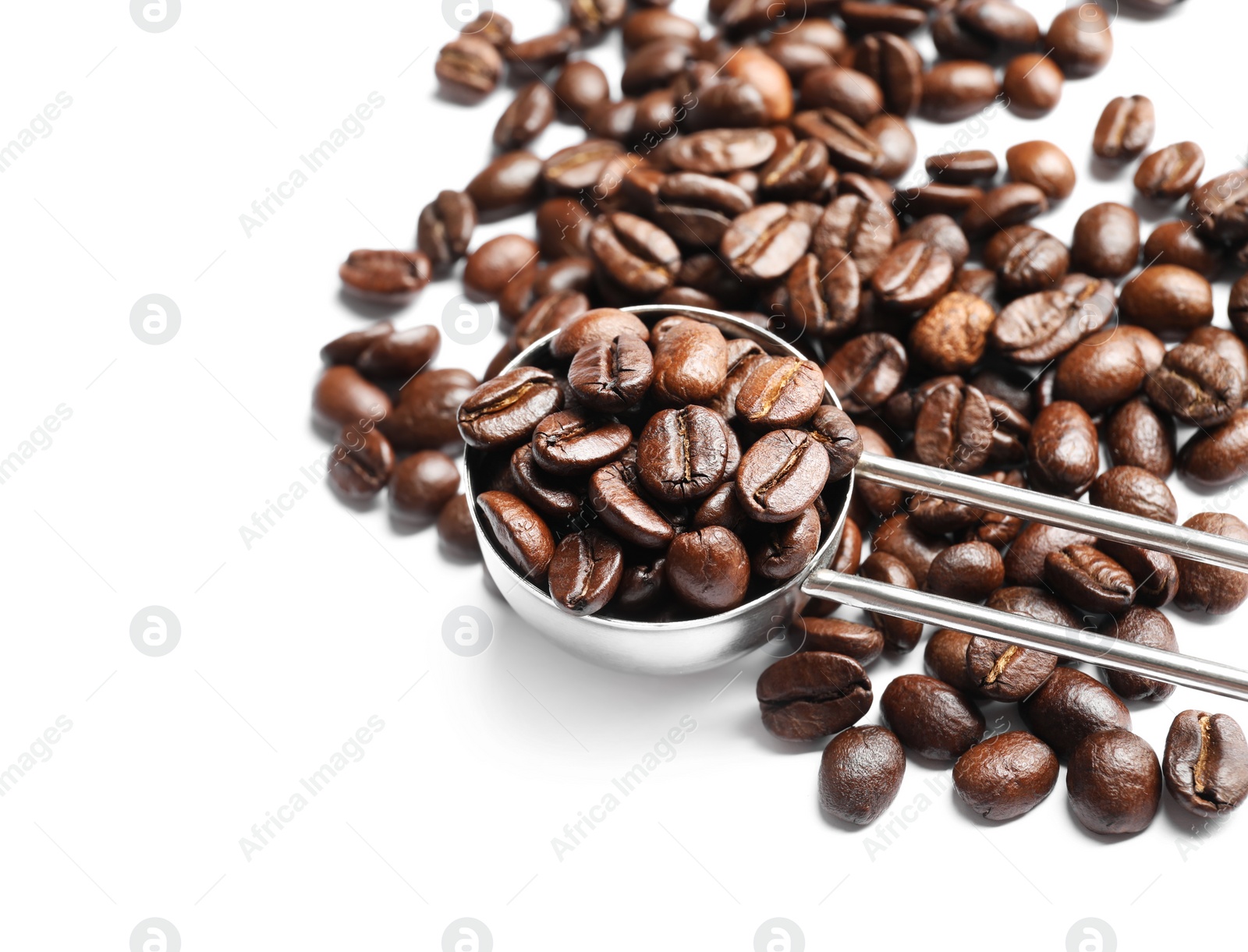 Photo of Scoop and roasted coffee beans on white background, closeup