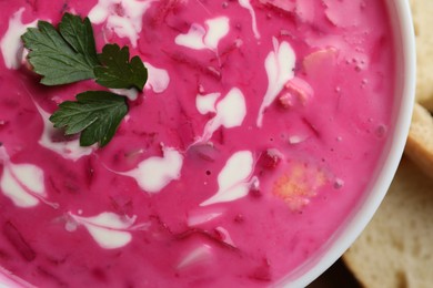 Photo of Delicious cold summer beet soup in bowl, closeup