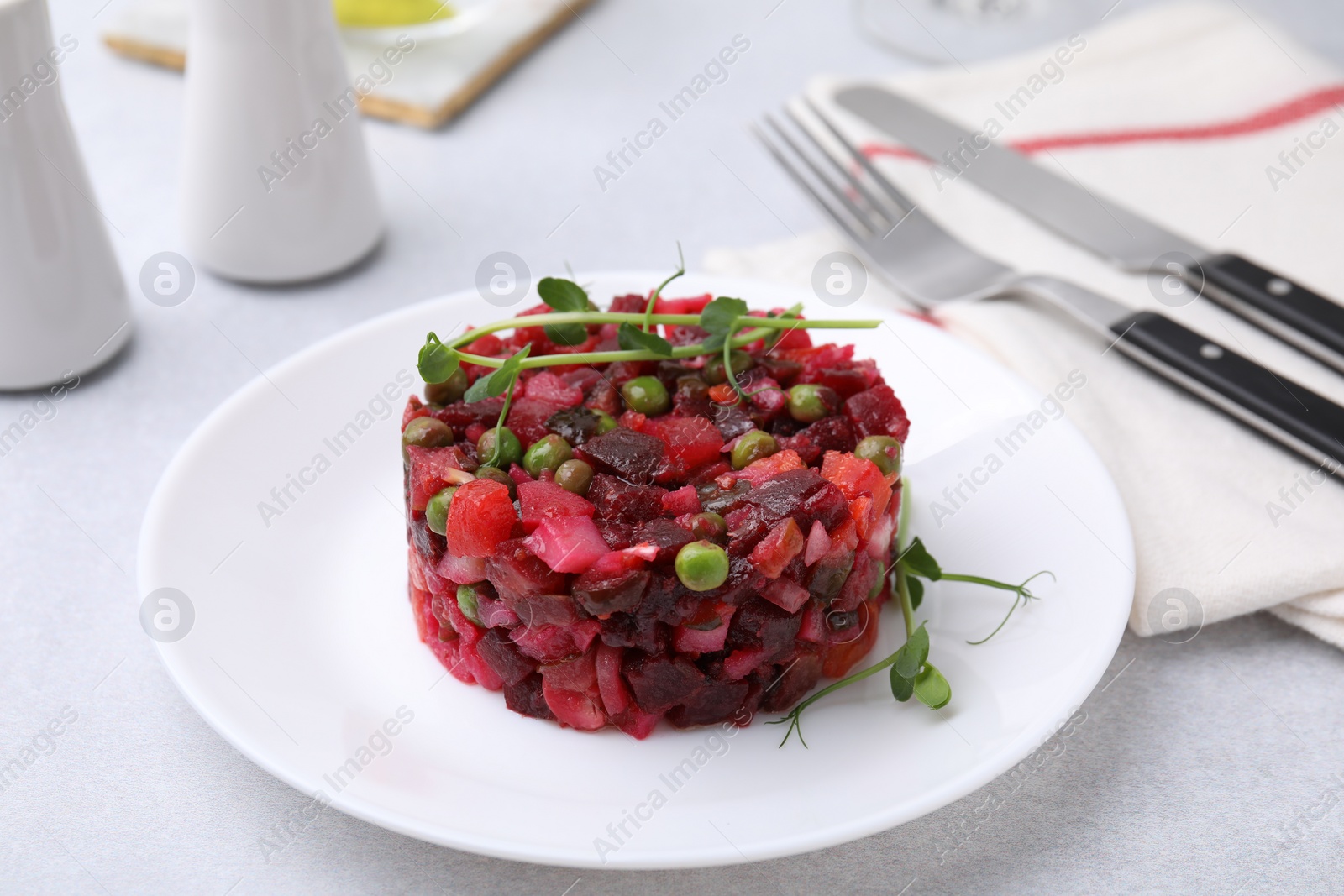 Photo of Delicious vinaigrette salad on light grey table, closeup