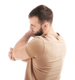 Young man suffering from pain in elbow on white background