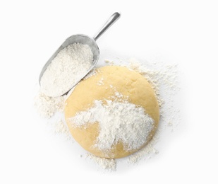 Photo of Raw dough and scoop with flour on white background, top view