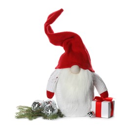 Photo of Funny Christmas gnome with gift box and festive decor on white background