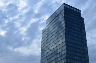 Exterior of beautiful modern skyscraper against blue sky