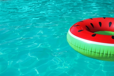 Inflatable ring floating in swimming pool on sunny day. Space for text