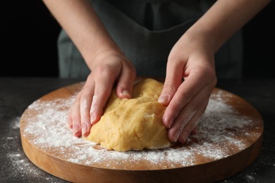 Photo of Making shortcrust pastry. Woman kneading dough at table, closeup