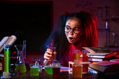 Photo of Child doing chemical research in laboratory. Dangerous experiment