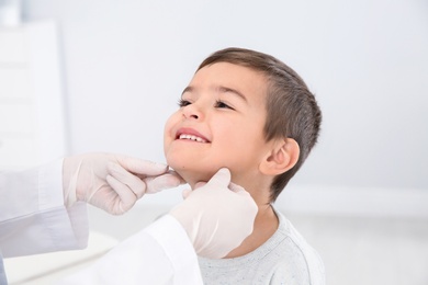 Photo of Dermatologist examining little boy's birthmark in clinic