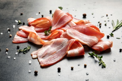 Photo of Raw bacon rashers on grey background