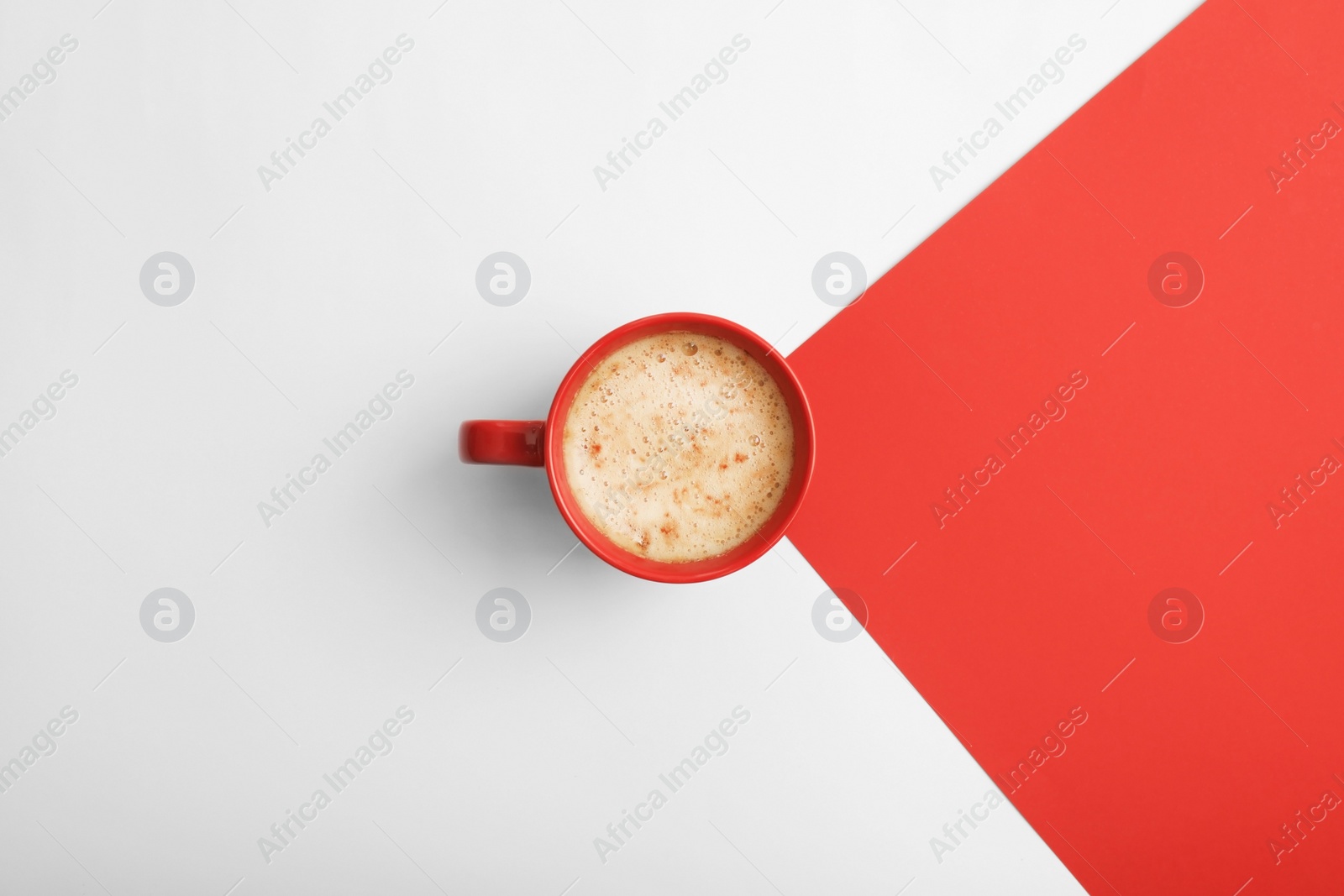 Photo of Cup of coffee on color background, top view. Space for text