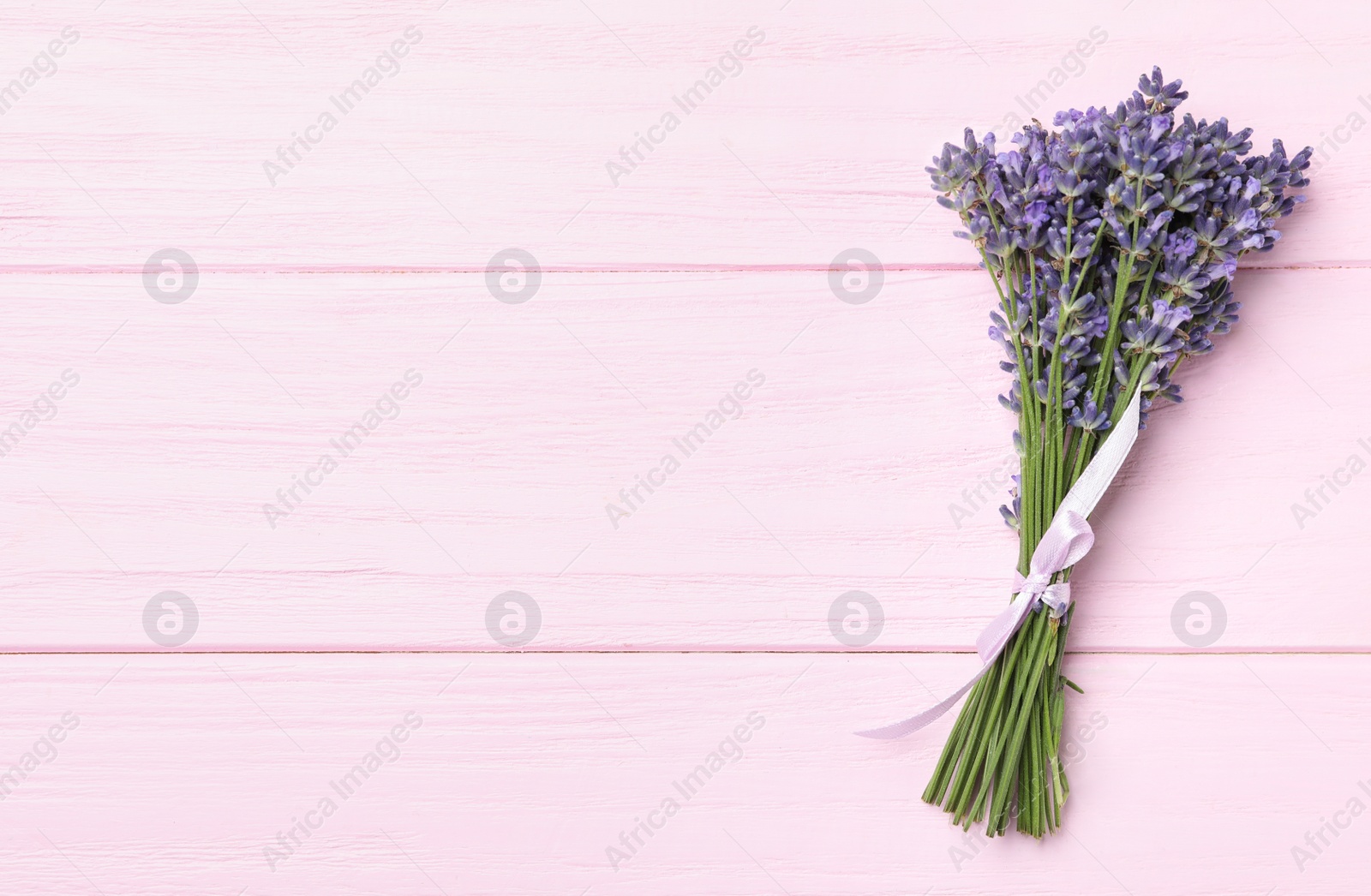 Photo of Beautiful lavender bouquet on pink wooden background, top view. Space for text