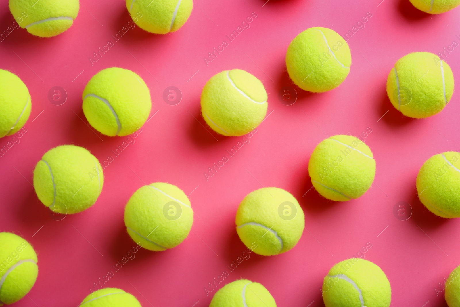 Photo of Tennis balls on pink background, flat lay. Sports equipment