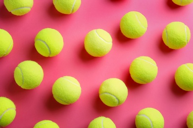 Tennis balls on pink background, flat lay. Sports equipment