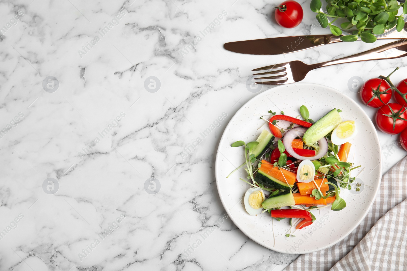 Photo of Salad with fresh organic microgreen in plate on white marble table, flat lay. Space for text