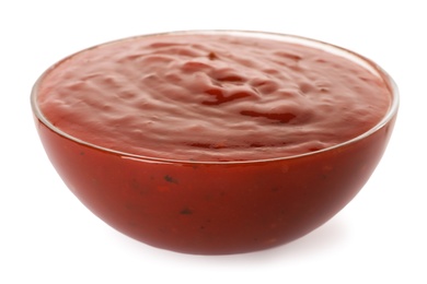 Photo of Glass bowl with red sauce isolated on white