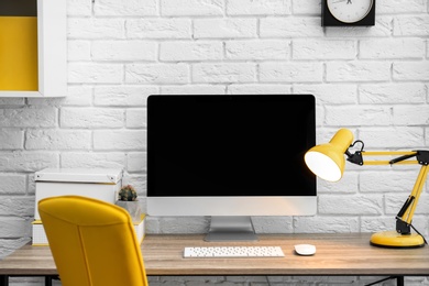 Photo of Comfortable workplace with computer on desk in home office