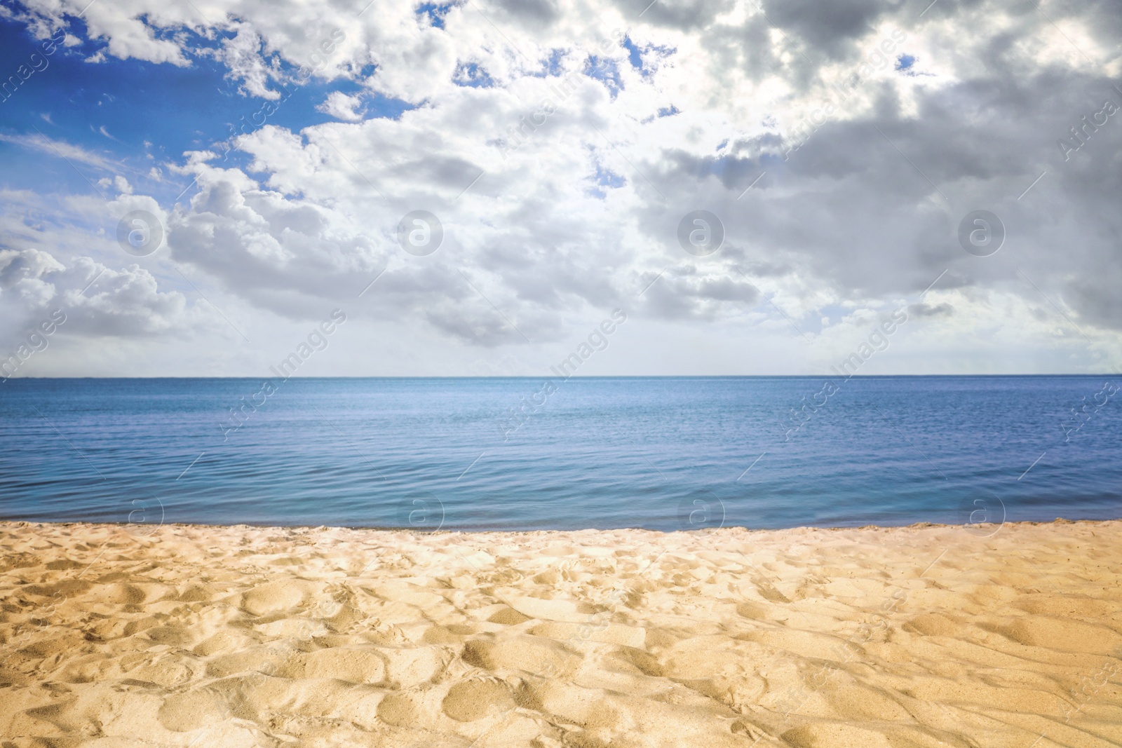 Image of Beautiful view of seascape and blue sky with white clouds on sunny day