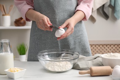 Preparing tasty baklava. Woman making dough at white table, closeup