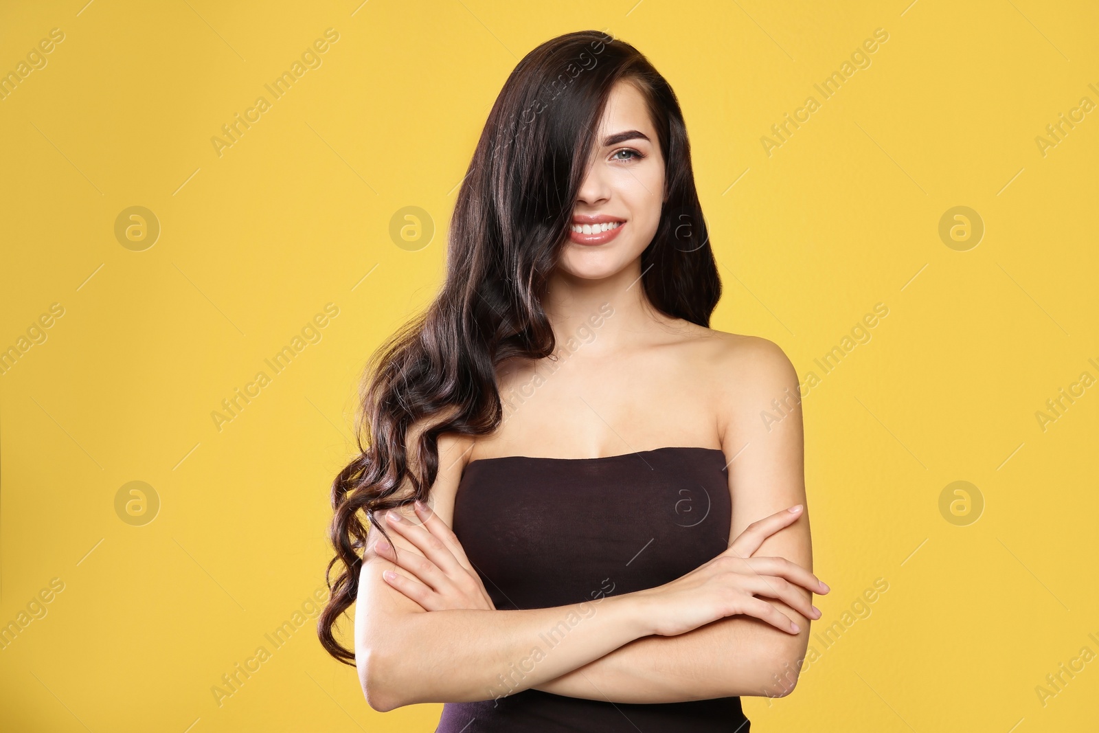 Photo of Portrait of beautiful model with gorgeous curly hair on color background