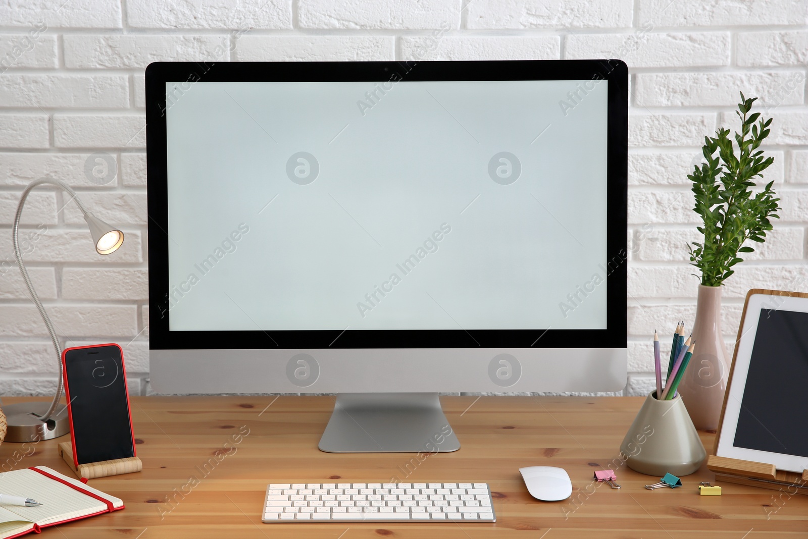 Photo of Stylish workplace with modern computer on desk