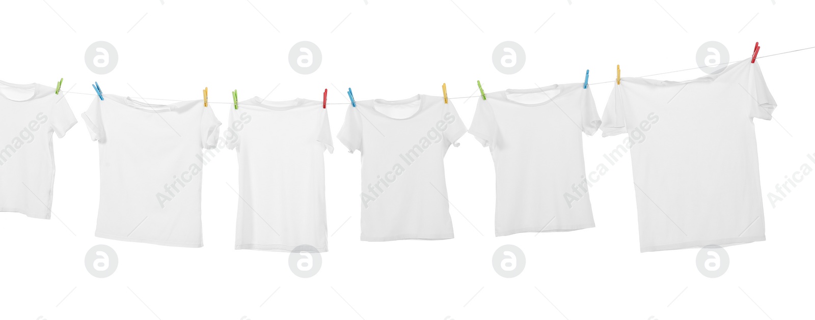 Photo of Many t-shirts drying on washing line isolated on white