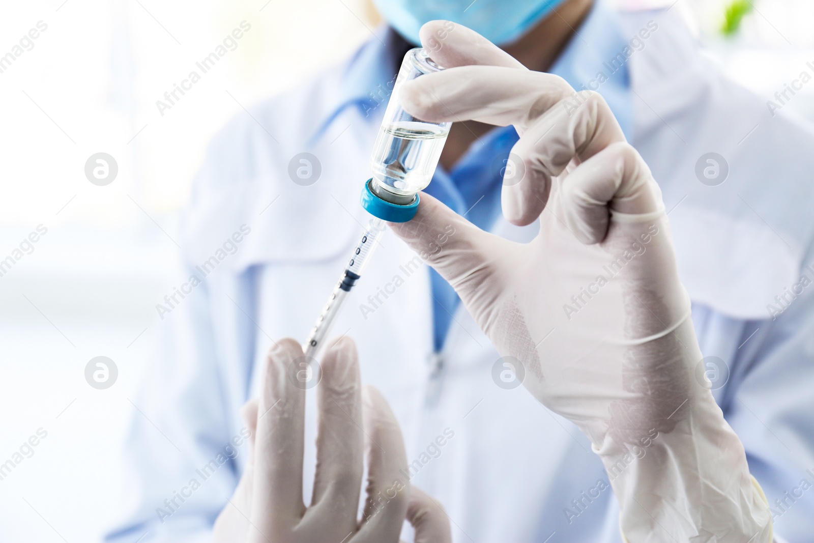 Photo of Female doctor with vial and syringe in hospital. Vaccination day