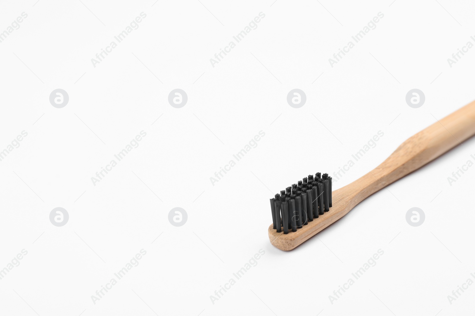 Photo of Bamboo toothbrush with charcoal bristle isolated on white