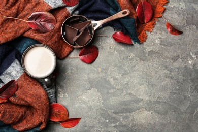 Photo of Flat lay composition with hot cozy drink and autumn leaves on table. Space for text