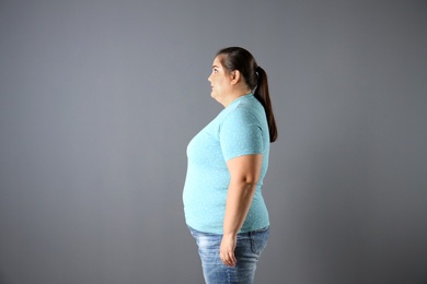 Photo of Portrait of overweight woman on gray background