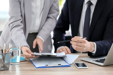 Young consultant working with client in office