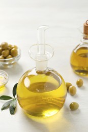 Photo of Bottle of fresh olive oil on white table