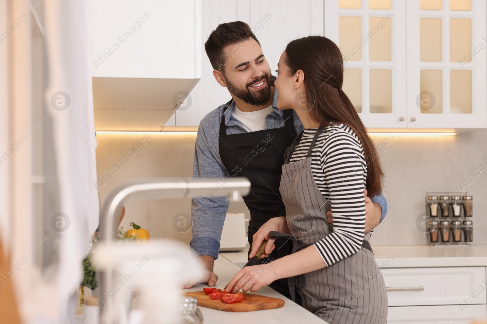 Photo of Happy lovely couple cooking together in kitchen